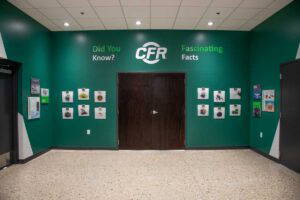 CFR History Wall displaying various graphics and images on a large, green wall.