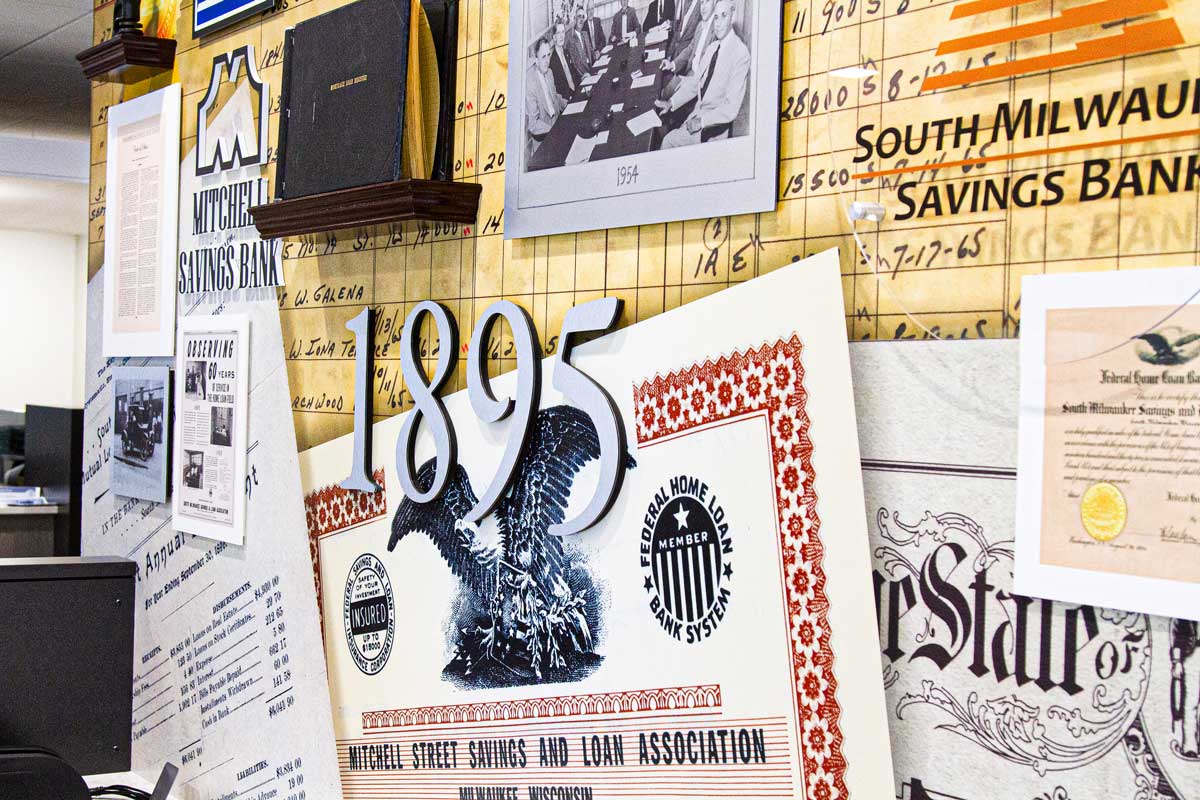 Close-up view of PyraMax Bank's history wall, displaying "1895" and various other graphics.