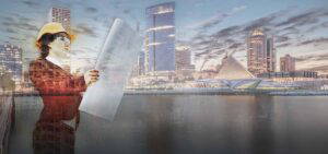 Female architect holding blueprints standing in front of Milwaukee skyline.