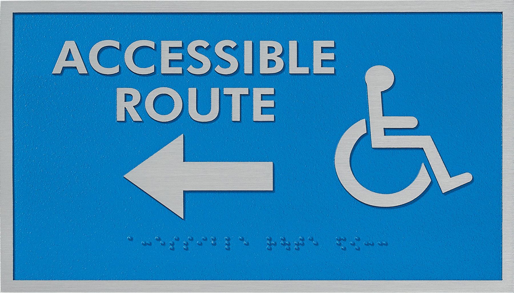 June 2025 Newsletter 21 Tactile ADA sign indicating an accessible route with a left-pointing arrow, raised silver text and icon, and Braille lettering on a blue background.