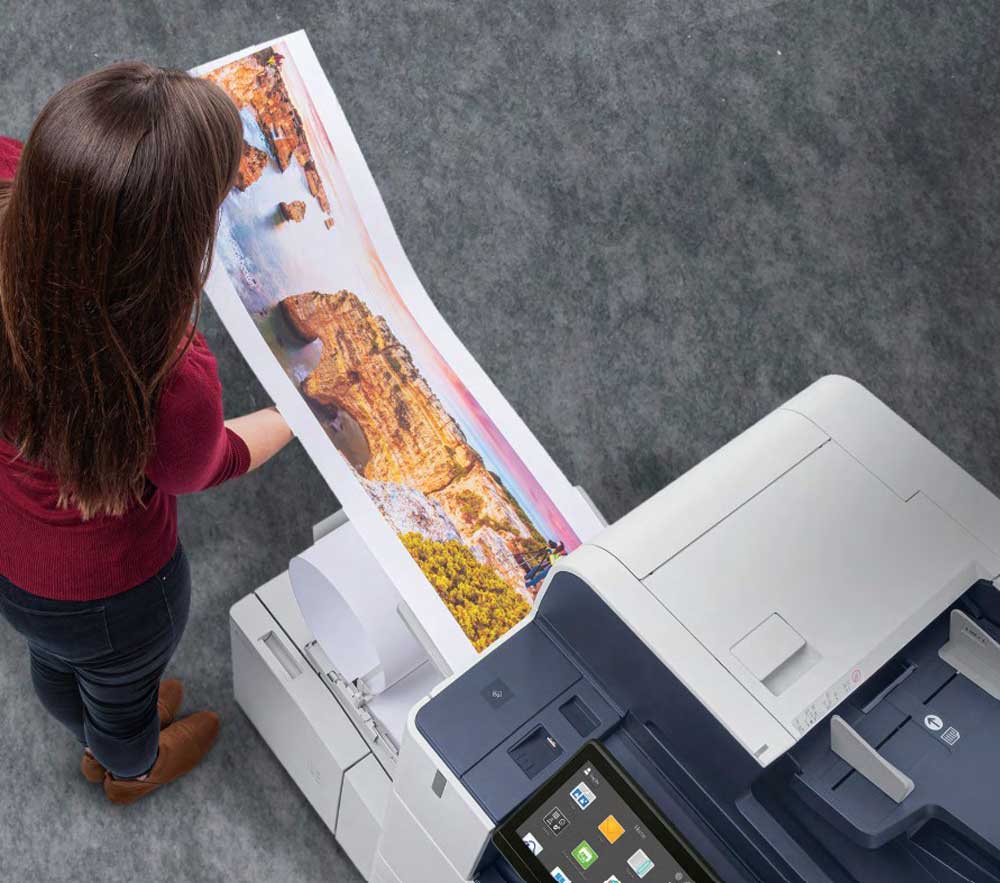 Overhead view of a woman at a Xerox printer.