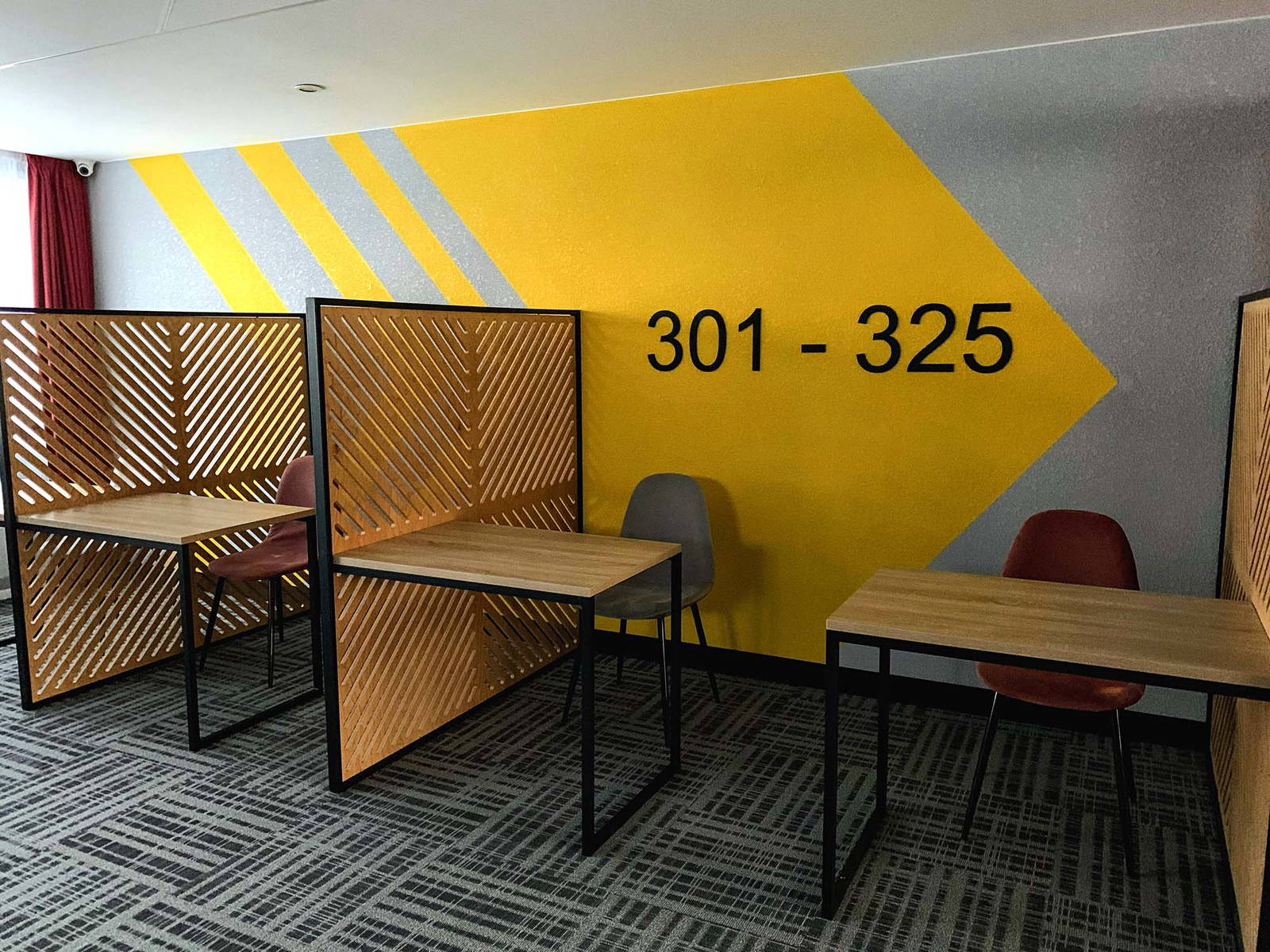 Adhesive wall graphic behind a workspace.