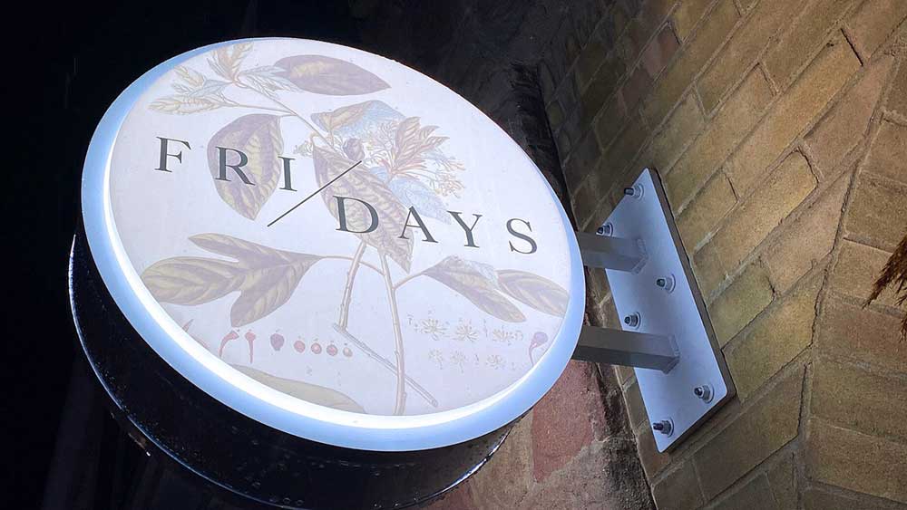 Round illuminated restaurant signage.