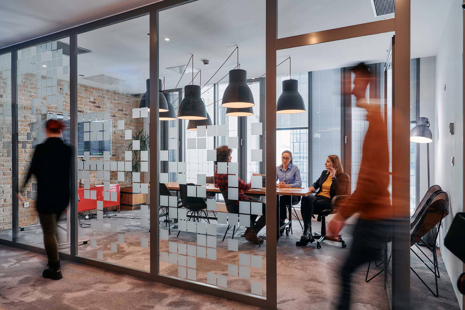 Frosted adhesive films on a class partition wall in an office.