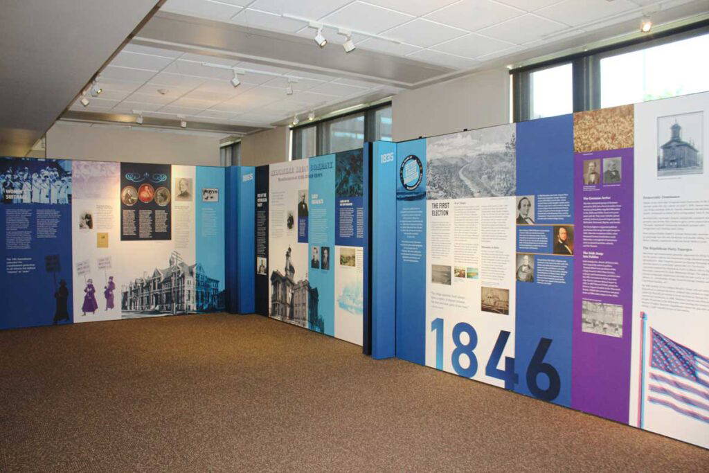 Large tension fabric display, highlighting important historical political information and images.