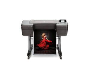 HP DesignJet Z6 prints a high-resolution fashion photograph of a woman in a red dress on a professional wide-format printer.