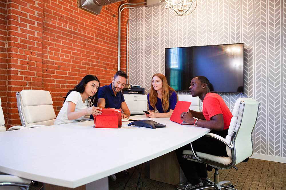 Coworkers meeting in a conference room.