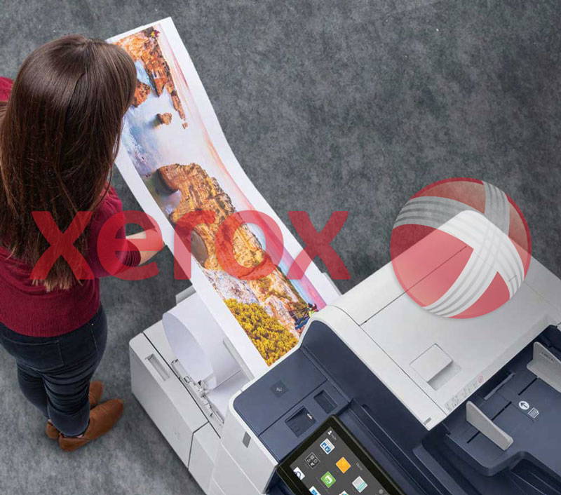 Above view of a woman working at a Xerox printer.