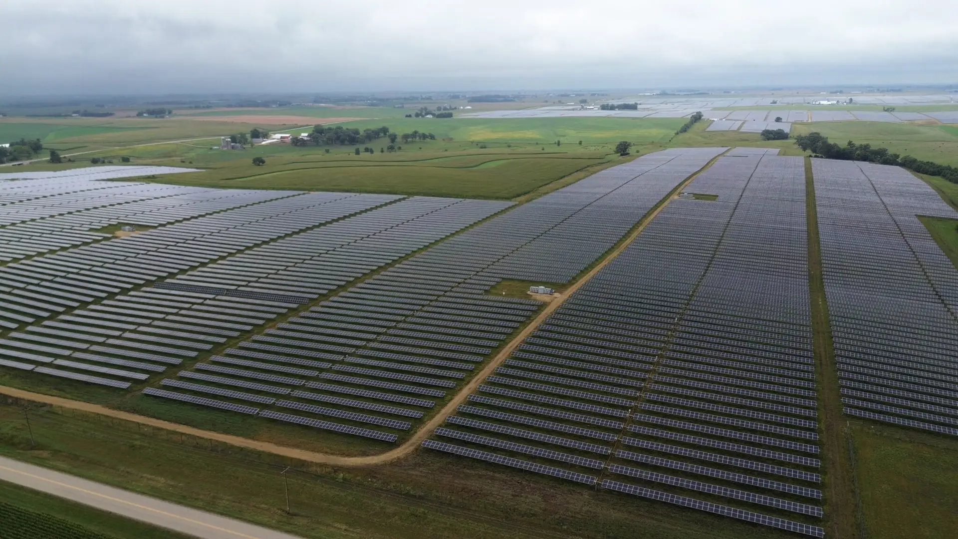BPI Color's 2024 Year in Review 6 Badger Hollow Solar Park aerial view of expansive solar panel fields stretching across rural farmland under an overcast sky in Wisconsin.