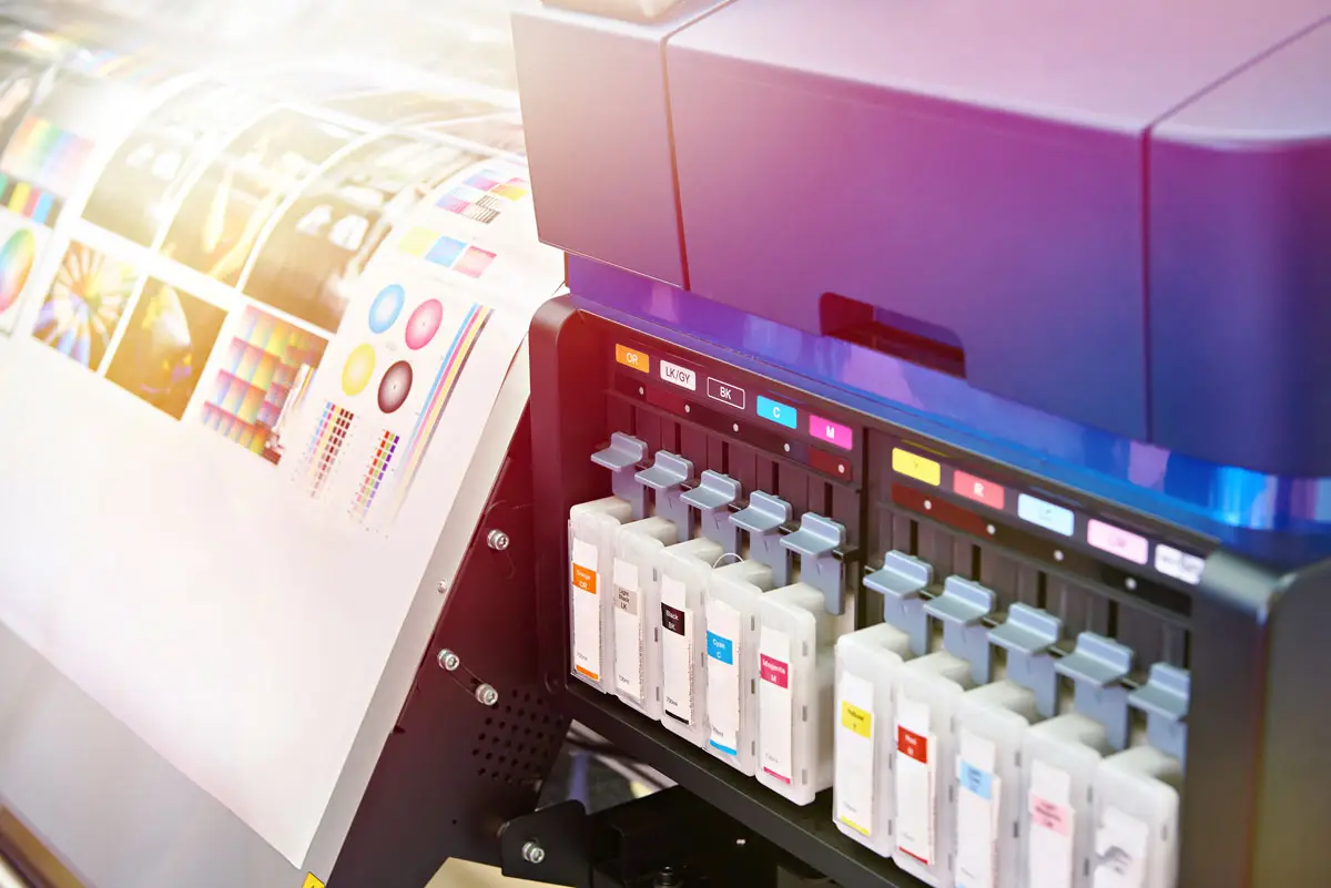 BPI Color's 2024 Year in Review 10 Digital Printing wide-format inkjet printer with vibrant color cartridges and detailed test prints showcasing precision output and color calibration tools.