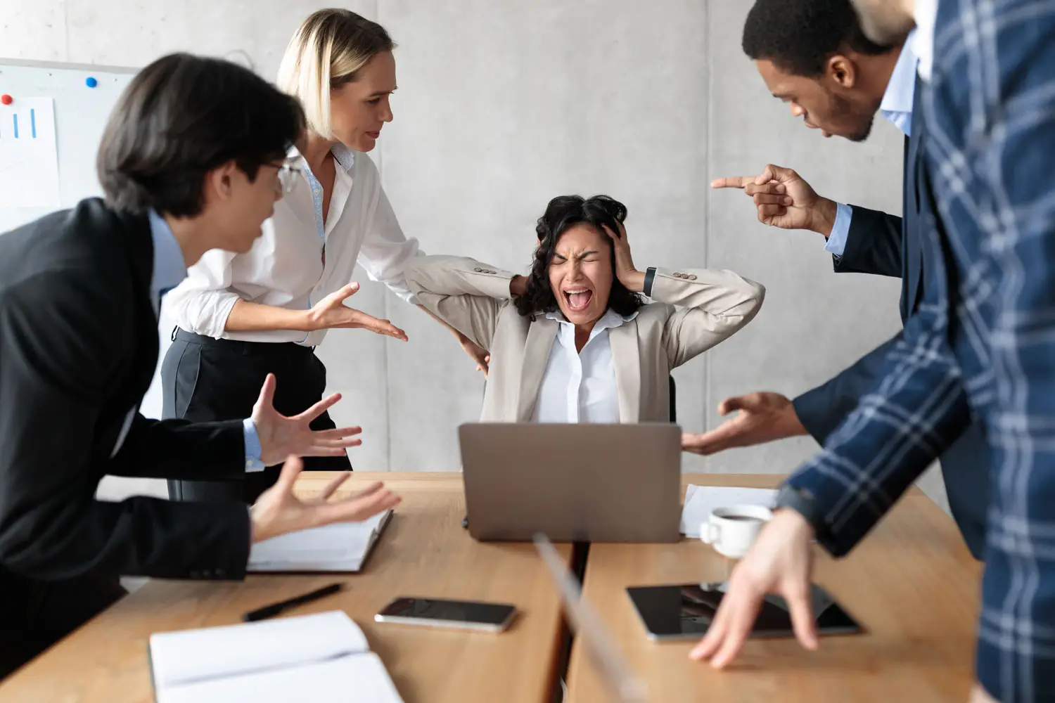 Unhappy Team in a tense office meeting as frustrated coworkers confront a stressed employee, highlighting workplace conflict and communication breakdown.