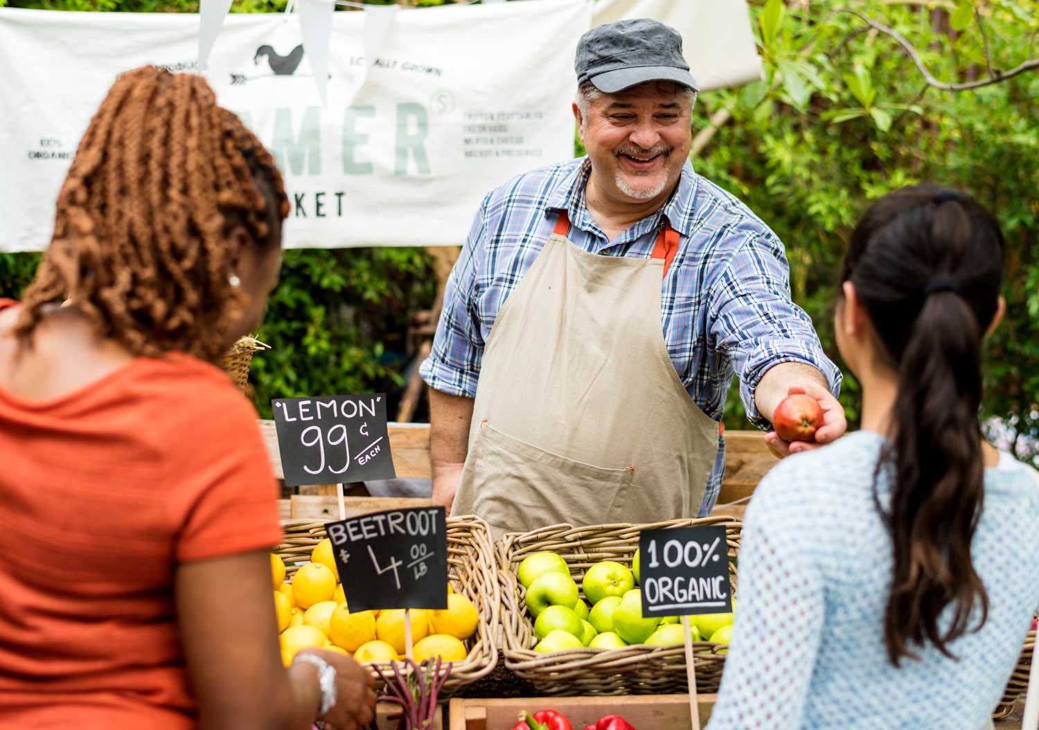 Promotional Products for Your Next Event 8 Three people talking at a farmer's market table.
