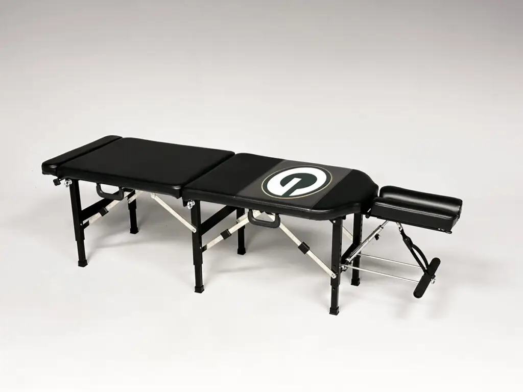 Thuli Tables full-length portable chiropractic table with custom Green Bay Packers “G” logo, featuring headrest and multiple panels.