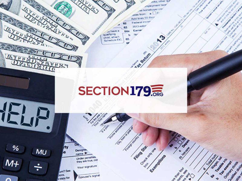 Hand filling out tax papers with a calculator that displays HELP